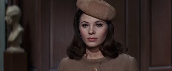 Movie still from “Valley of the Dolls” (1967), directed by Mark Robson – A woman wearing a tan hat and a brown jacket; Close Up shot, High angle