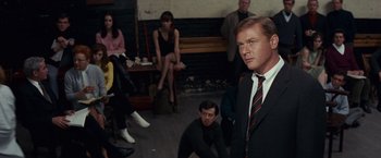 Movie still from “Valley of the Dolls” (1967), directed by Mark Robson – A group of people sitting and standing in a room; Medium shot, Over the shoulder angle
