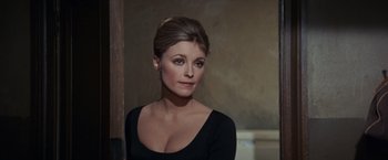 Movie still from “Valley of the Dolls” (1967), directed by Mark Robson – A woman in a black shirt is posing for a picture; Close Up shot, Over the shoulder angle