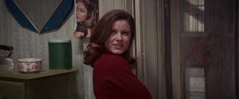 Movie still from “Valley of the Dolls” (1967), directed by Mark Robson – A young woman with long brown hair wearing a red shirt; Close Up shot, Over the shoulder angle