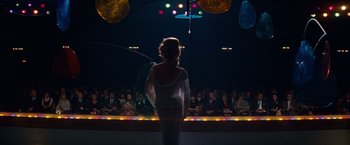 Movie still from “Valley of the Dolls” (1967), directed by Mark Robson – A woman in a white dress standing in front of an audience; Wide shot, Over the shoulder angle