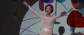 Movie still from “Valley of the Dolls” (1967), directed by Mark Robson – A wax statue of a woman in a white dress with her arms outstreched; Medium shot, Low angle