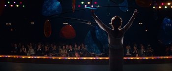 Movie still from “Valley of the Dolls” (1967), directed by Mark Robson – A woman in a white dress holding a hula hoop in front of an audience; Wide shot, Low angle