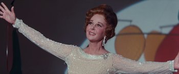 Movie still from “Valley of the Dolls” (1967), directed by Mark Robson – An older woman wearing a white dress and a diamond necklace; Close Up shot, Low angle