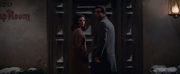 Movie still from “Valley of the Dolls” (1967), directed by Mark Robson – A man and a woman standing next to each other in front of a door; Medium shot, Low angle