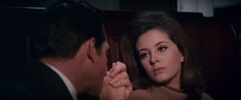 Movie still from “Valley of the Dolls” (1967), directed by Mark Robson – A man and a woman holding hands in front of each other; Close Up shot, High angle