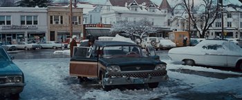 Movie still from “Valley of the Dolls” (1967), directed by Mark Robson – An old car parked on the side of the street; Wide shot, Low angle