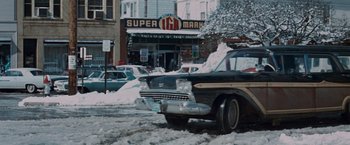Movie still from “Valley of the Dolls” (1967), directed by Mark Robson – A car parked on the side of the road in the snow; Wide shot, Low angle