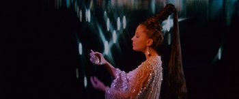 Movie still from “Valley of the Dolls” (1967), directed by Mark Robson – A woman in a white dress holding a camera; Medium shot, Low angle