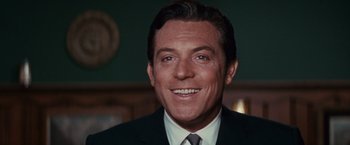Movie still from “Valley of the Dolls” (1967), directed by Mark Robson – A person wearing a suit and tie; Close Up shot, Over the shoulder angle