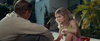 Movie still from “Valley of the Dolls” (1967), directed by Mark Robson – A woman sitting next to a man on the ground; Medium shot, Over the shoulder angle