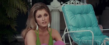 Movie still from “Valley of the Dolls” (1967), directed by Mark Robson – A woman sitting in front of a chair in a room; Close Up shot, Over the shoulder angle