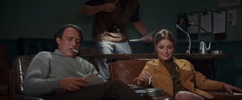 Movie still from “Valley of the Dolls” (1967), directed by Mark Robson – A man and a woman sitting at a table; Medium shot, High angle