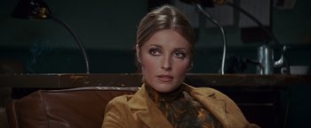 Movie still from “Valley of the Dolls” (1967), directed by Mark Robson – A person sitting on a couch; Close Up shot, Over the shoulder angle