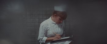 Movie still from “Valley of the Dolls” (1967), directed by Mark Robson – A woman in a nurse's uniform writing on a notepad; Medium shot, High angle
