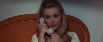 Movie still from “Valley of the Dolls” (1967), directed by Mark Robson – A woman holding a phone up to her ear; Close Up shot, High angle