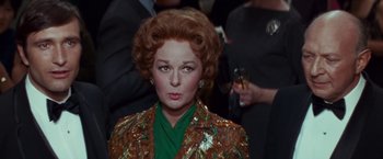 Movie still from “Valley of the Dolls” (1967), directed by Mark Robson – An older woman in a green shirt and a brown jacket; Close Up shot, Over the shoulder angle