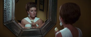 Movie still from “Valley of the Dolls” (1967), directed by Mark Robson – A woman is looking at her reflection in a mirror; Close Up shot, Over the shoulder angle