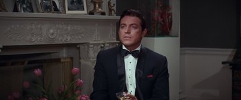 Movie still from “Valley of the Dolls” (1967), directed by Mark Robson – A person wearing a suit and tie; Close Up shot, Over the shoulder angle
