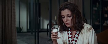 Movie still from “Valley of the Dolls” (1967), directed by Mark Robson – A woman looking at a watch in a room; Close Up shot, High angle