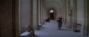 Movie still from “Valmont” (1989), directed by Milos Forman – Two women in medieval garb walking through a hallway; Extreme Wide shot, High angle