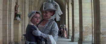 Movie still from “Valmont” (1989), directed by Milos Forman – A woman and a child dressed in period clothing; Medium shot, Low angle