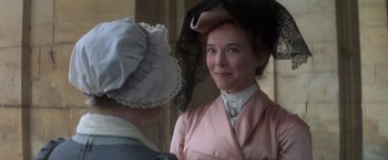 Movie still from “Valmont” (1989), directed by Milos Forman – A woman in a pink dress and a woman in a black hat; Close Up shot, Over the shoulder angle