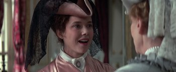 Movie still from “Valmont” (1989), directed by Milos Forman – A woman in a pink dress and a pink hat; Close Up shot, Over the shoulder angle