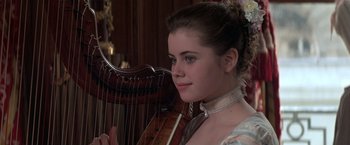 Movie still from “Valmont” (1989), directed by Milos Forman – A young woman is holding an instrument in her hands; Close Up shot, Over the shoulder angle