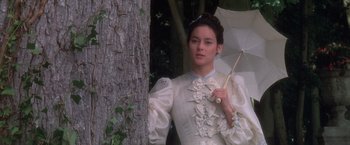 Movie still from “Valmont” (1989), directed by Milos Forman – A woman in a white dress holding an umbrella; Medium shot, Low angle