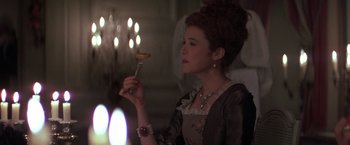 Movie still from “Valmont” (1989), directed by Milos Forman – A woman holding a fork in her hand; Close Up shot, High angle
