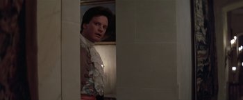 Movie still from “Valmont” (1989), directed by Milos Forman – A young man in a victorian outfit looking into a mirror; Medium shot, Over the shoulder angle