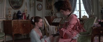 Movie still from “Valmont” (1989), directed by Milos Forman – A woman in a pink dress and a girl in a white dress; Medium shot, Over the shoulder angle