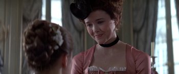Movie still from “Valmont” (1989), directed by Milos Forman – A woman in a pink dress and a black hat; Close Up shot, Over the shoulder angle