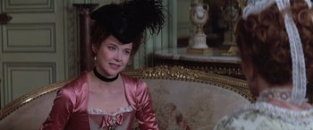 Movie still from “Valmont” (1989), directed by Milos Forman – A woman in a pink dress and a black hat; Close Up shot, Over the shoulder angle