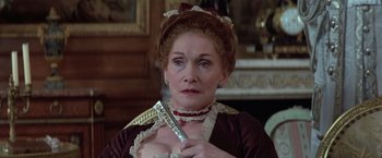 Movie still from “Valmont” (1989), directed by Milos Forman – An older woman holding a pair of razor blades in her hands; Close Up shot, Over the shoulder angle