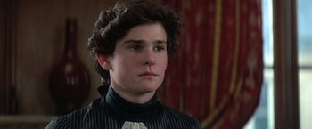 Movie still from “Valmont” (1989), directed by Milos Forman – A young man wearing a black and white striped shirt; Close Up shot, Over the shoulder angle