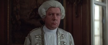 Movie still from “Valmont” (1989), directed by Milos Forman – A person wearing a suit and wig; Close Up shot, Over the shoulder angle