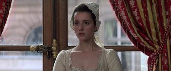 Movie still from “Valmont” (1989), directed by Milos Forman – A young woman wearing a white dress and a white hat; Close Up shot, Over the shoulder angle