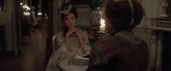 Movie still from “Valmont” (1989), directed by Milos Forman – A woman sitting in front of a candle in front of a mirror; Medium shot, Over the shoulder angle