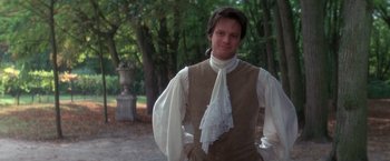 Movie still from “Valmont” (1989), directed by Milos Forman – A man in a brown vest and a white shirt; Medium shot, Over the shoulder angle