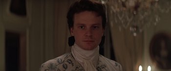 Movie still from “Valmont” (1989), directed by Milos Forman – A young man wearing a white shirt and a neck tie; Close Up shot, High angle