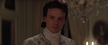 Movie still from “Valmont” (1989), directed by Milos Forman – A young man wearing a white shirt and a floral shirt; Close Up shot, High angle