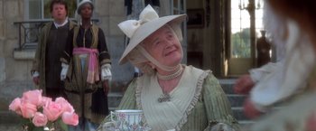Movie still from “Valmont” (1989), directed by Milos Forman – An older woman wearing a hat and holding a tea cup; Medium shot, Low angle