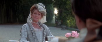 Movie still from “Valmont” (1989), directed by Milos Forman – A woman wearing a white dress and a white hat; Medium shot, Over the shoulder angle