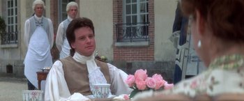 Movie still from “Valmont” (1989), directed by Milos Forman – A man sitting at a table with a cup of coffee; Medium shot, Over the shoulder angle