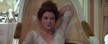 Movie still from “Valmont” (1989), directed by Milos Forman – A woman in a white dress sitting in a chair; Close Up shot, Low angle
