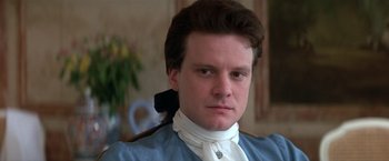 Movie still from “Valmont” (1989), directed by Milos Forman – A person wearing a shirt and tie; Close Up shot, Over the shoulder angle