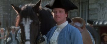 Movie still from “Valmont” (1989), directed by Milos Forman – A man wearing a hat standing next to a horse; Close Up shot, Low angle