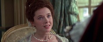 Movie still from “Valmont” (1989), directed by Milos Forman – A person wearing a necklace; Close Up shot, Over the shoulder angle